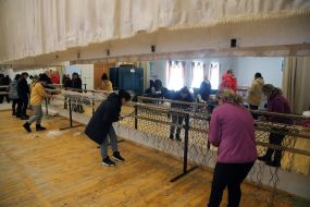 Volunteers weave camouflage nets