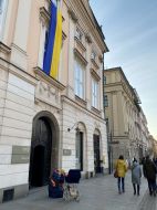 The flag of Ukraine is unfurled on a building in Krakow