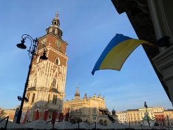 The flag of Ukraine is unfurled on a building in Krakow