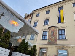The flag of Ukraine is unfurled on a building in Krakow