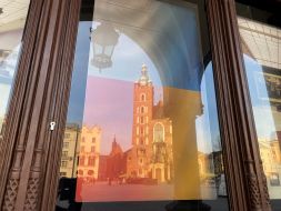 Flag of Ukraine in the window of the building, on the central square
