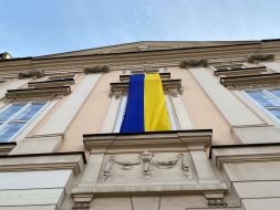 The flag of Ukraine is unfurled on a building in Krakow