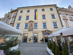 The flag of Ukraine is unfurled on a building in Krakow