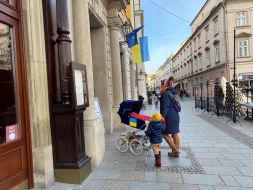 The flag of Ukraine is unfurled on a building in Krakow