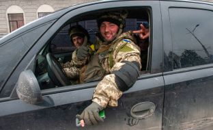 Ukrainian servicemen patrol the streets of Kharkiv