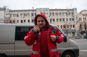 The nurse speaks on a walkie-talkie