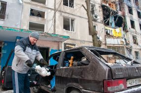 A man near a car smashed in Kharkiv after shelling by the Russian military occupiers