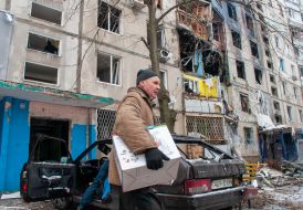 Man near a house destroyed in the shelling by the Russian military occupiers in a residential area of Kharkiv