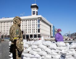 Military and woman near the barricade in the center of Kyiv