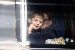 Boy in the evacuation train at the train station