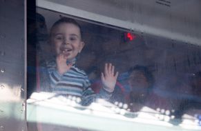Boy in the evacuation train at the train station