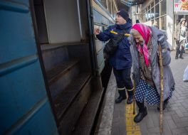 Old woman at the train station