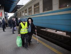 Old woman at the train station