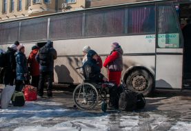 People get on an evacuation bus in Kharkiv