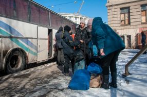 People get on an evacuation bus in Kharkiv