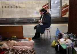 Woman reading a book in the subway in Kiev