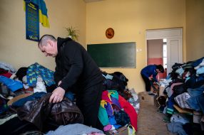 Clothes for migrants are laid out in the classroom of one of the schools in Drohobych