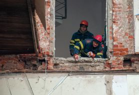 Rescuers dismantle the rubble of a residential building in Kharkiv destroyed after the shelling by the Russian military occupiers