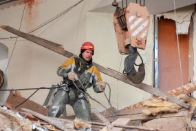 Rescuers dismantle the rubble of a residential building in Kharkiv destroyed after the shelling by the Russian military occupiers