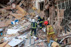 Rescuers dismantle the rubble of a residential building in Kharkiv destroyed after the shelling by the Russian military occupiers