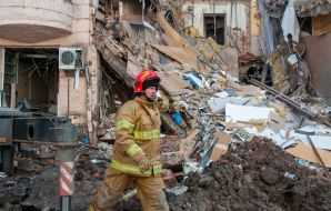 Rescuers dismantle the rubble of a residential building in Kharkiv destroyed after the shelling by the Russian military occupiers