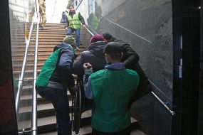 Volunteers help people with disabilities at the train station in Lviv