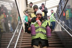Volunteers pour tea to IDPs at the train station in Lviv