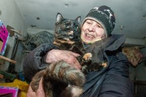 Woman  with a cat in a bomb shelter
