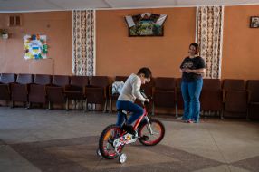 The boy rides a bicycle