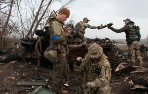 Ukrainian soldiers take captured ammunition