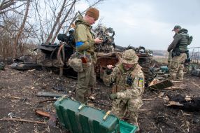 Ukrainian soldiers take captured ammunition