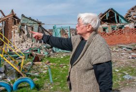 A local resident near residential buildings destroyed as a result of shelling in Chuguev