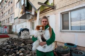 The girl is holding a dog in Kharkiv