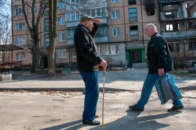 A man walks near a ruined house in Kharkiv