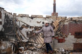 Woman near the ruined house