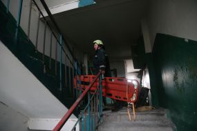 Rescuer with a stretcher in a dilapidated house