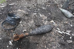 An unexploded ordnance on a village street