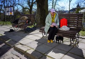 A woman walks with a dog in Lviv