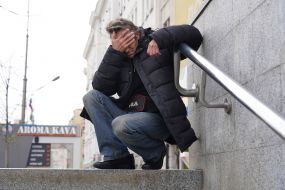 A man covered his eyes with his hands at the entrance to the metro station "Constitution Square" in Kharkiv