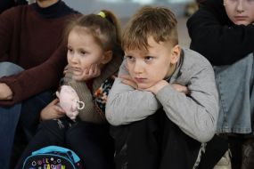 Children watch the play at the metro station in Kharkiv
