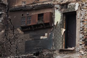 Kitchen cabinet with a ceramic rooster on the wall of a residential building in Borodyanka destroyed by shelling