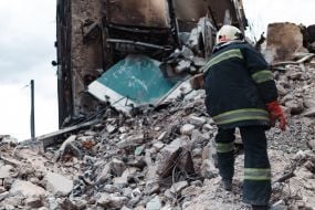 Rescuer dismantles the rubble of a residential building in Borodyanka destroyed as a result of explosions and shelling