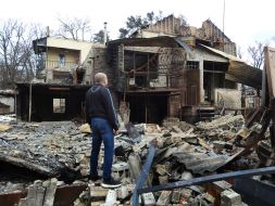 A man stands near the house in Gostomel (Kyiv region) destroyed by the occupiers