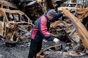 A man near a burned car