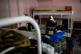 A volunteer from the Hospitallers Medical Battalion reads a book
