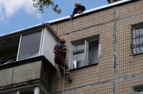 A rescuer is looking for people in a house damaged in the explosion in Kharkiv