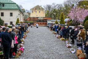 The priest is blessing the easter baskets in Lviv