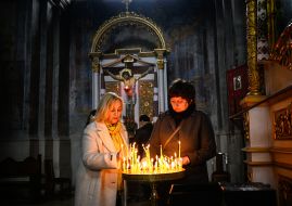 Believers put candles in the church