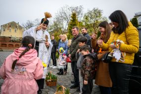The priest is blessing the easter baskets in Lviv