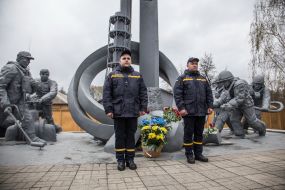 Laying flowers at the monument to "Those who saved the world" in Chernobyl